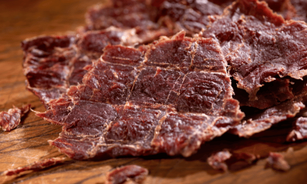 Jerky on cutting board. Dehydrated meat