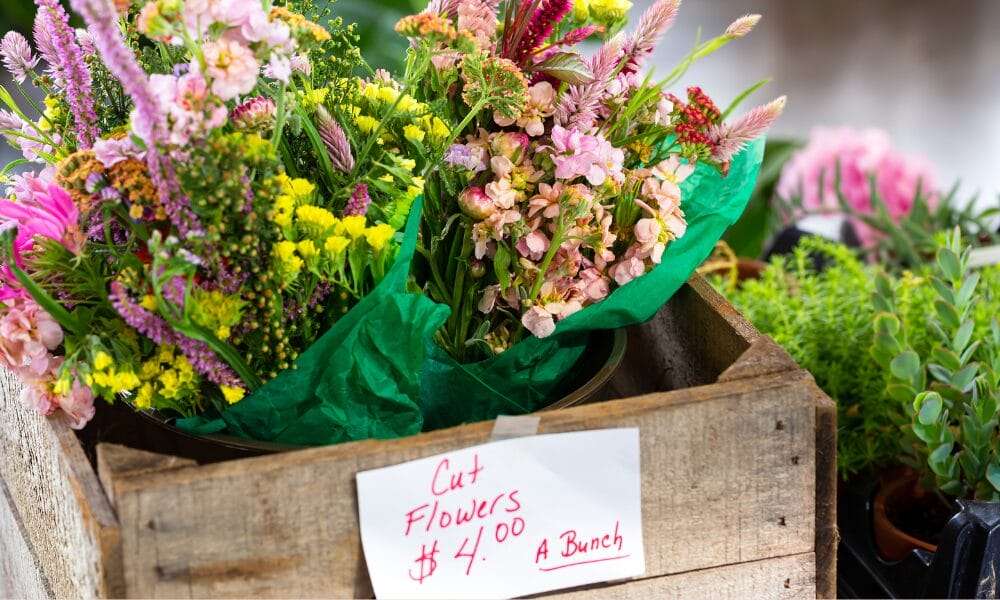 A crate of Valentine's day flowers with a sign on it.